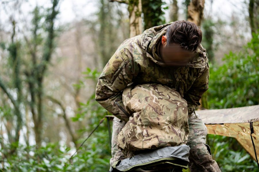 military personnel packing a bergen