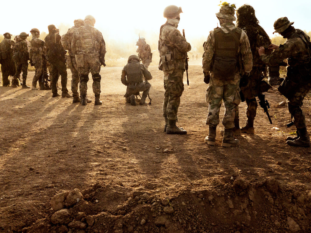 group of military personnel on dry ground